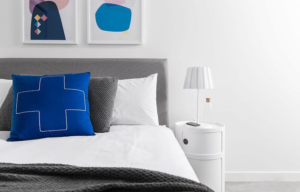 blue pillow on a bed